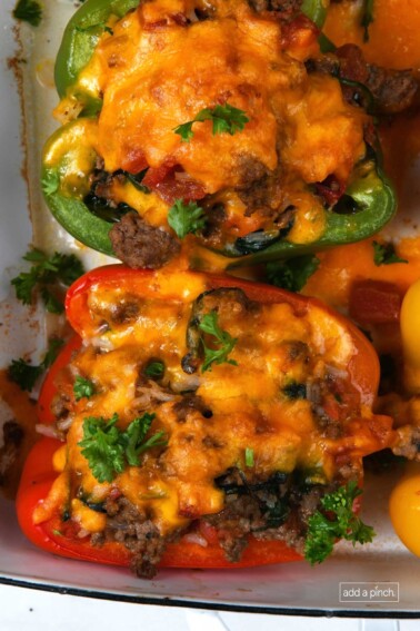 Photo of stuffed peppers in a baking dish.